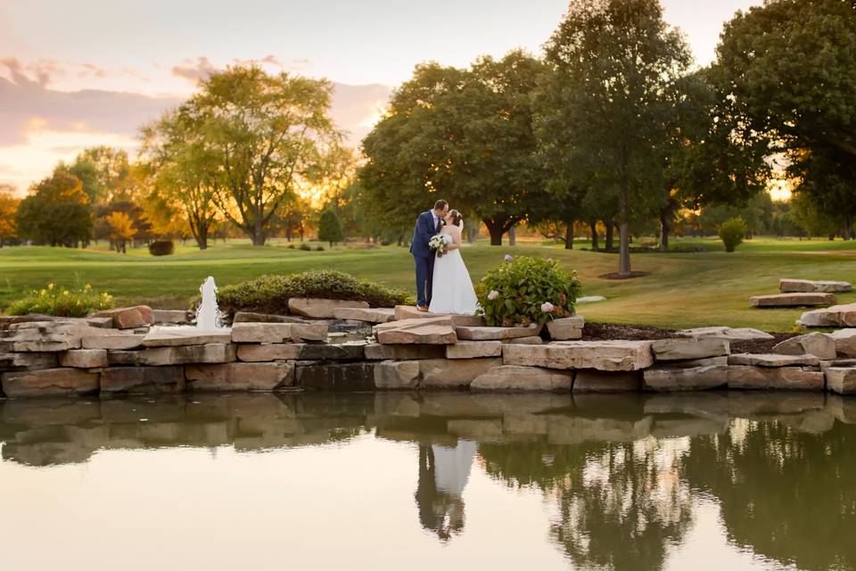 Couple kiss by the pond