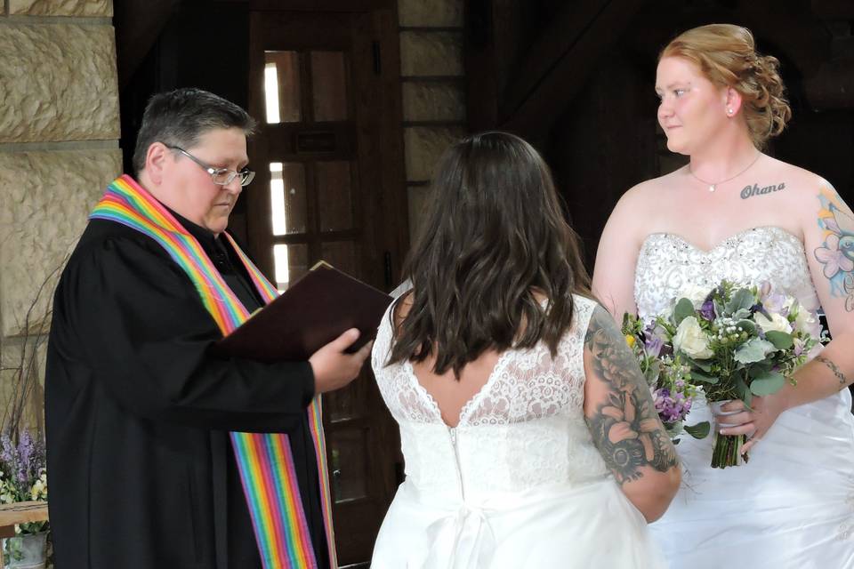 The officiant with the lovely brides