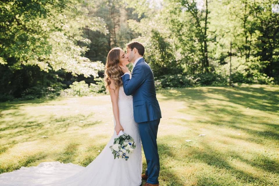 Bride and groom kissing in the park