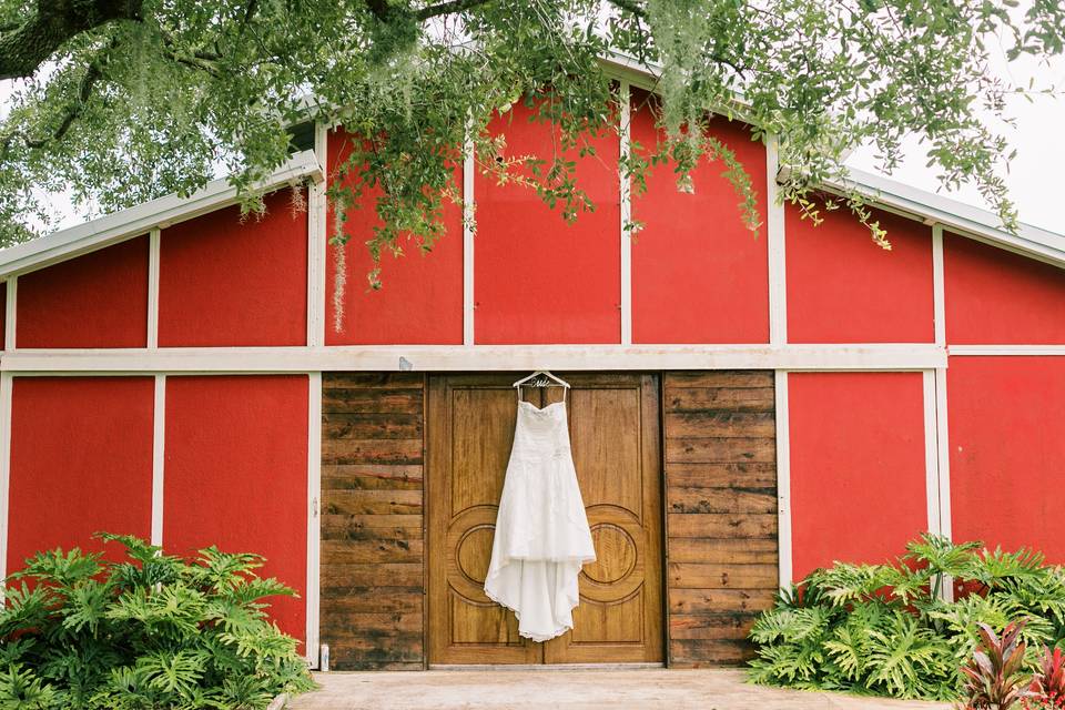 Wedding dress hanging on barn