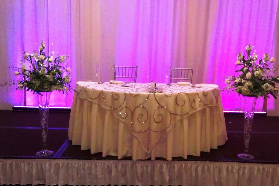Bride and Groom Table – our linens, flower décor and up-lighting
