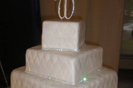 All white wedding cake with white bow