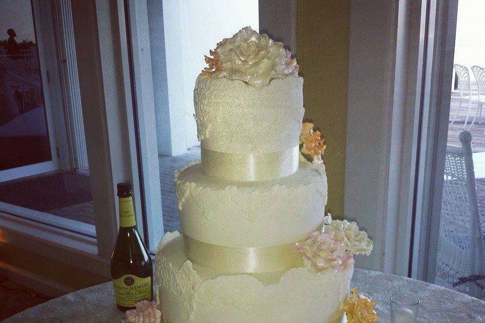 All white wedding cake with flowers