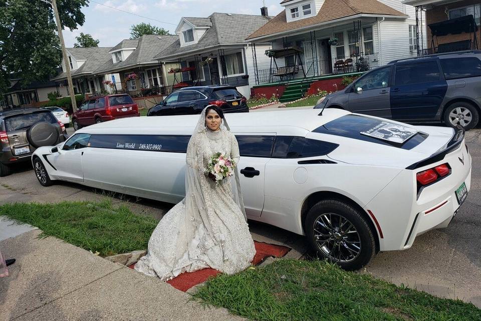 Bride in front of Corvette limo