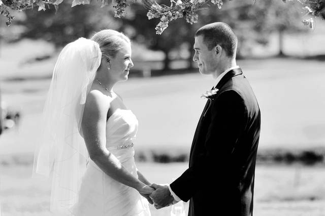 During a brief part of the ceremony, the bride and groom made a heart shape against the golf course venue behind them.