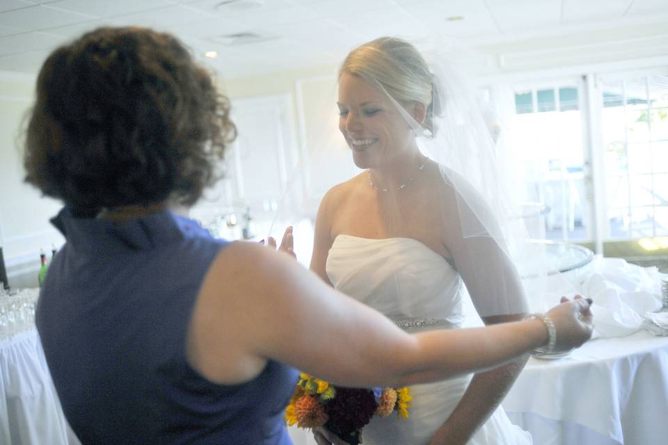 The bride's sister checks her veil