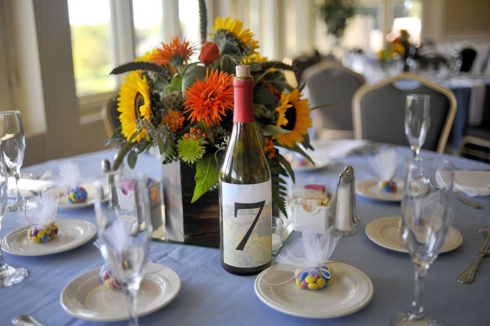 Table decorations and wine bottle table numbers at the reception
