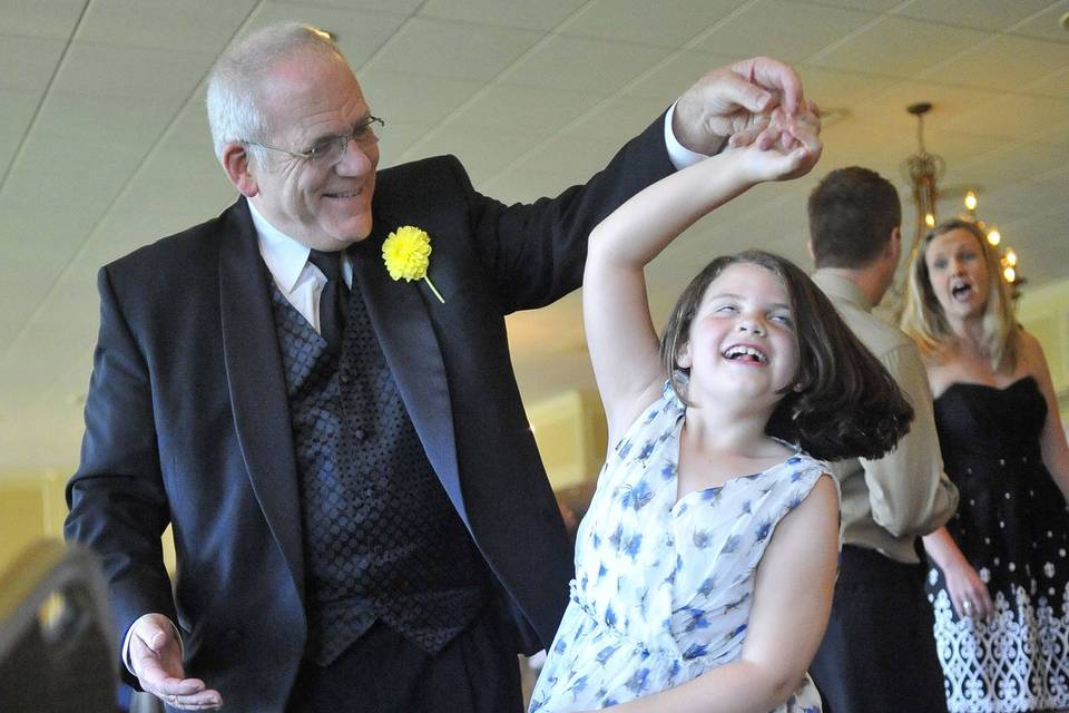 The bride's father dances with a grand daughter.
