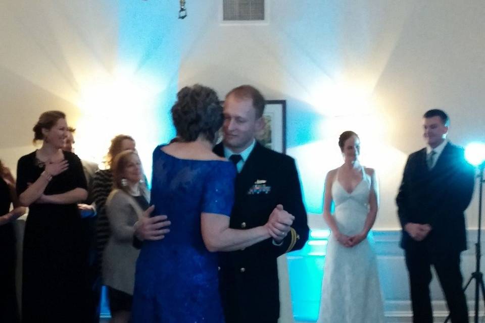 Groom dancing with Mom.  Naval Dress uniform.