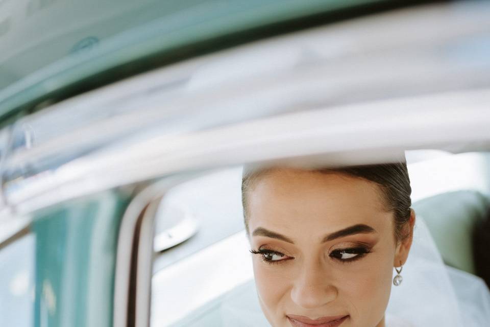 Bride looks out car window