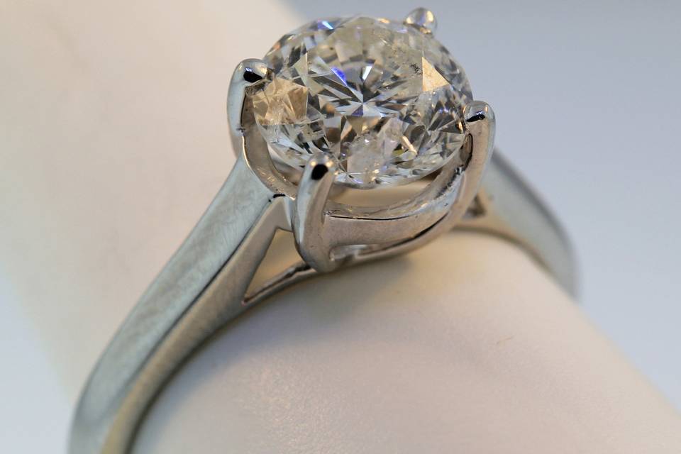 Traditional solitaire style diamond engagement ring. This is available with any shape or size center stone into this ring. It can also be made in yellow gold or platinum.