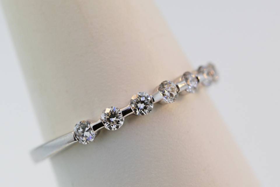 18 karat white gold diamond wedding band. Bar set diamonds going half way around .48 carats total. $2,600.00