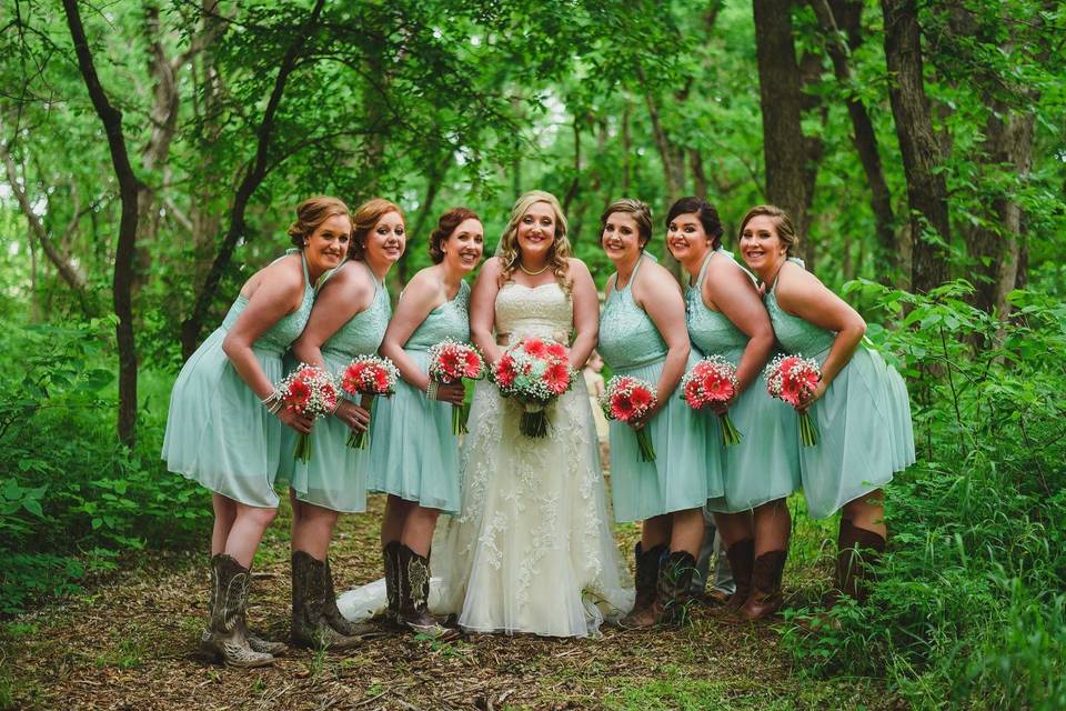 Bride and her bridesmaids in the woods