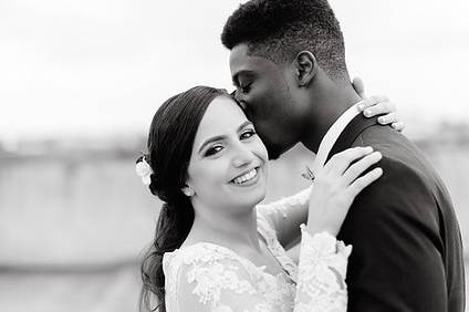 Groom kissing his bride on the cheek