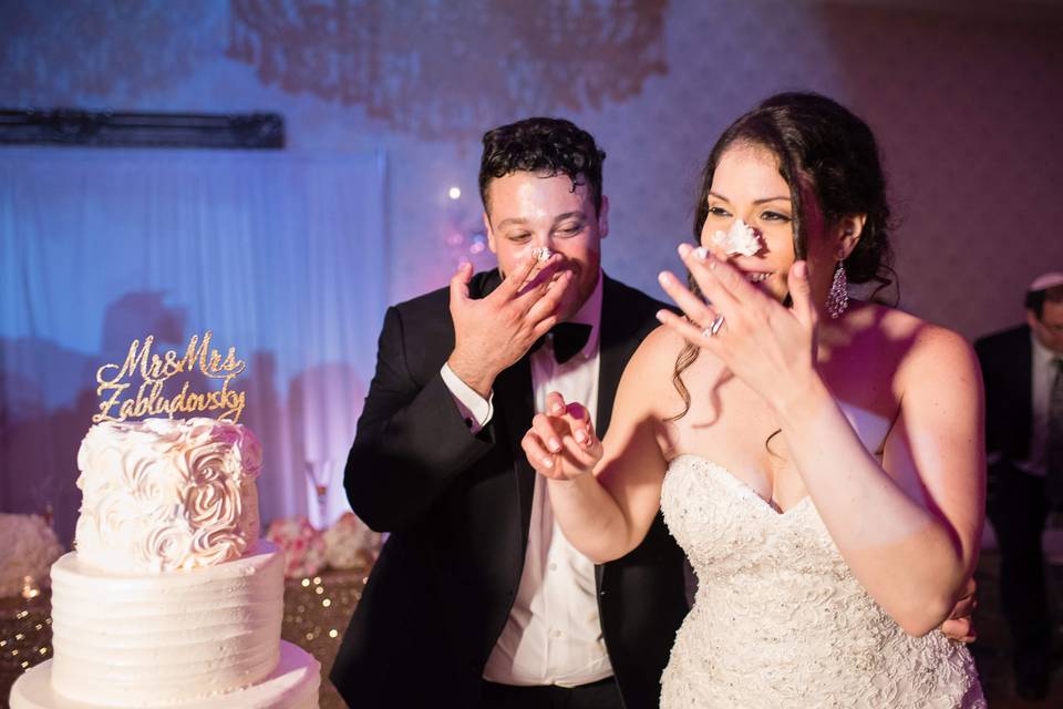 Happy couple cutting cake