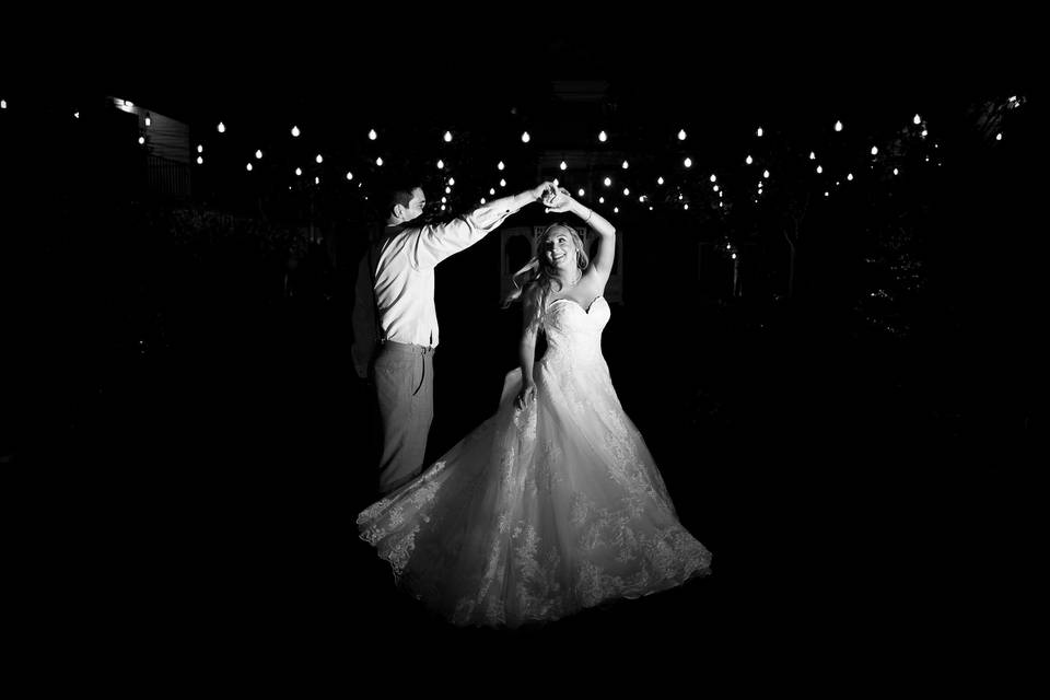 Bride twirls under lights