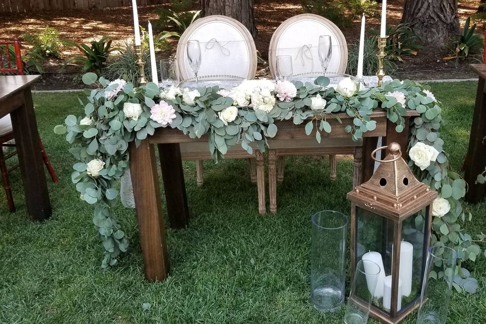 Sweetheart table garland with lush white flowers.