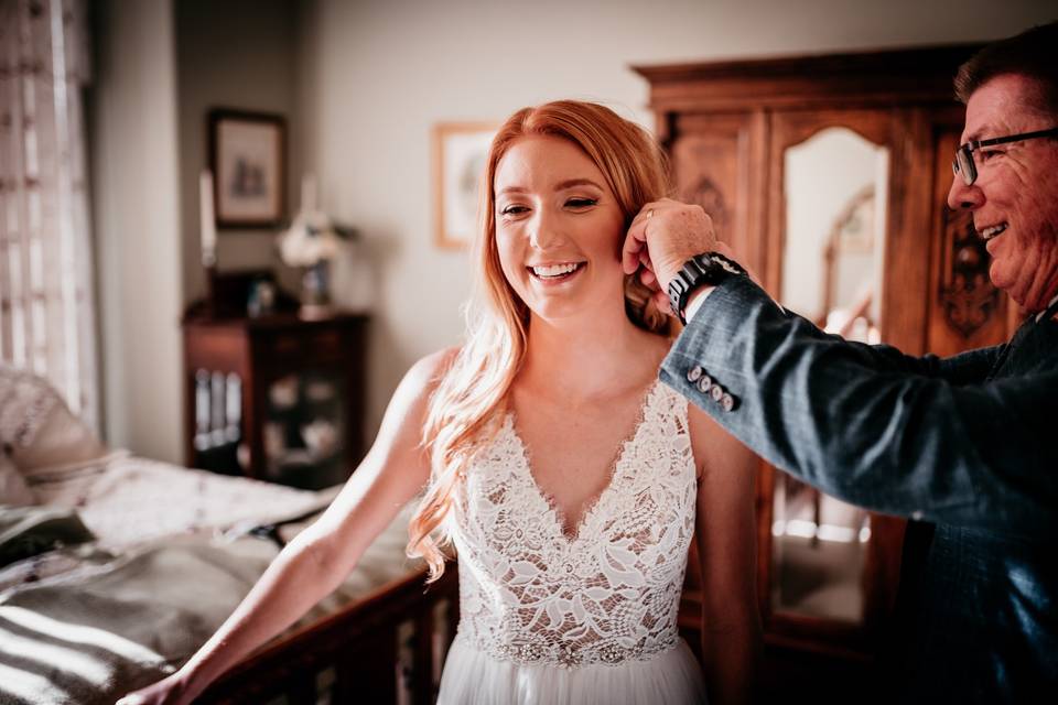 Dad putting in brides earrings