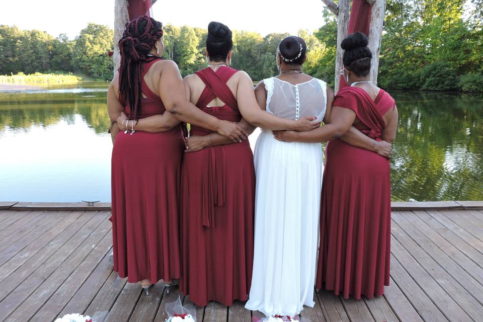Bride with her bridesmaids by the water