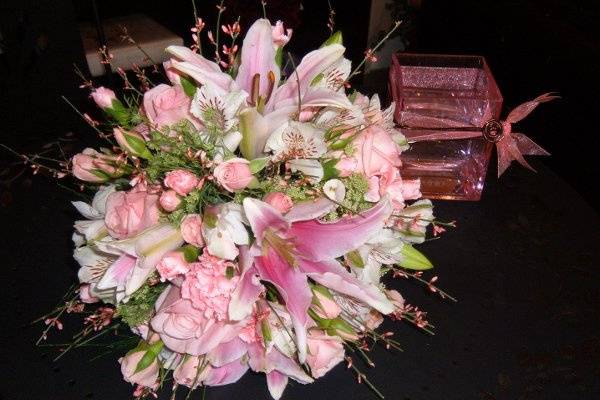 Shades of pink lilies, spray sweetheart roses, pale pink mini carnations and fragrant genestra