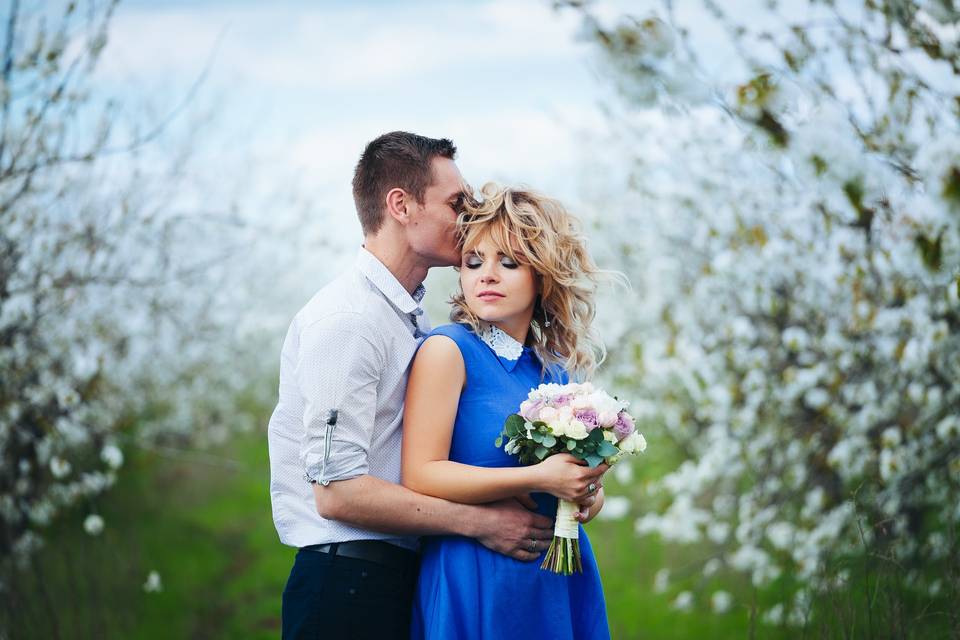 Couple embracing with bouquet