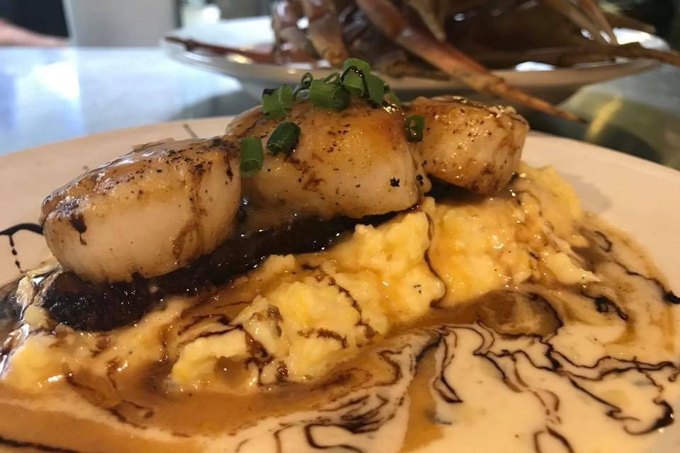 Seared Scallops and Pork Belly over Grits with Lobster Butter and Beurre Blanc.