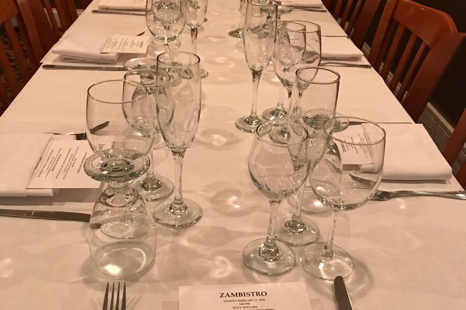 Long table, cutlery, and glassware