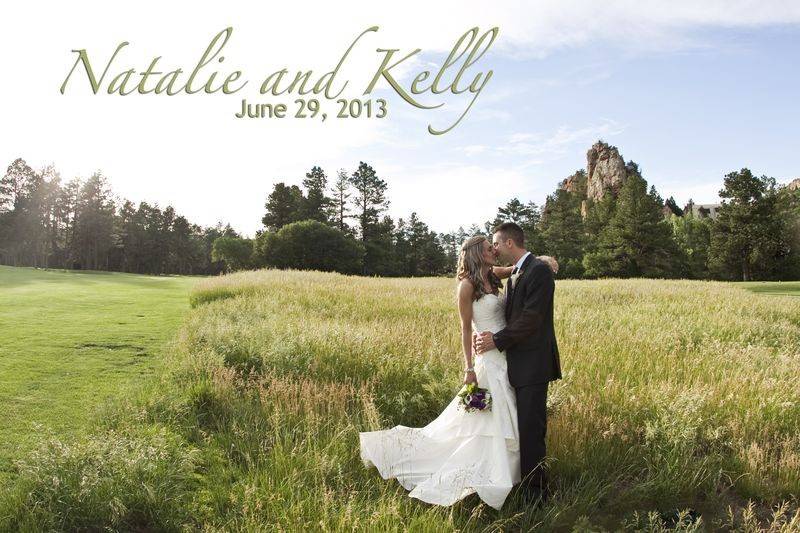 Newlyweds kissing in the field