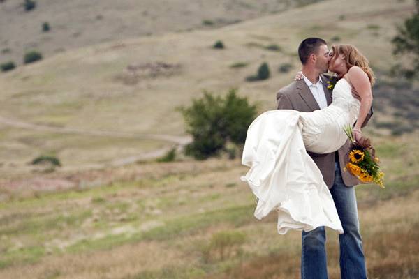 Groom carries his bride for a kiss