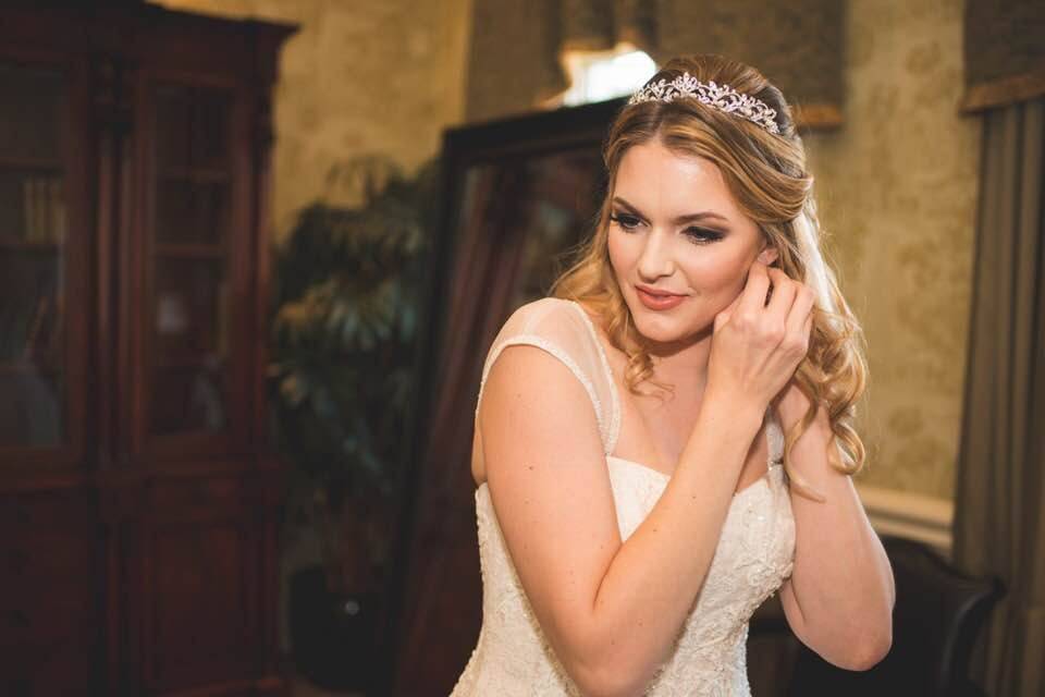 Bride putting on earring