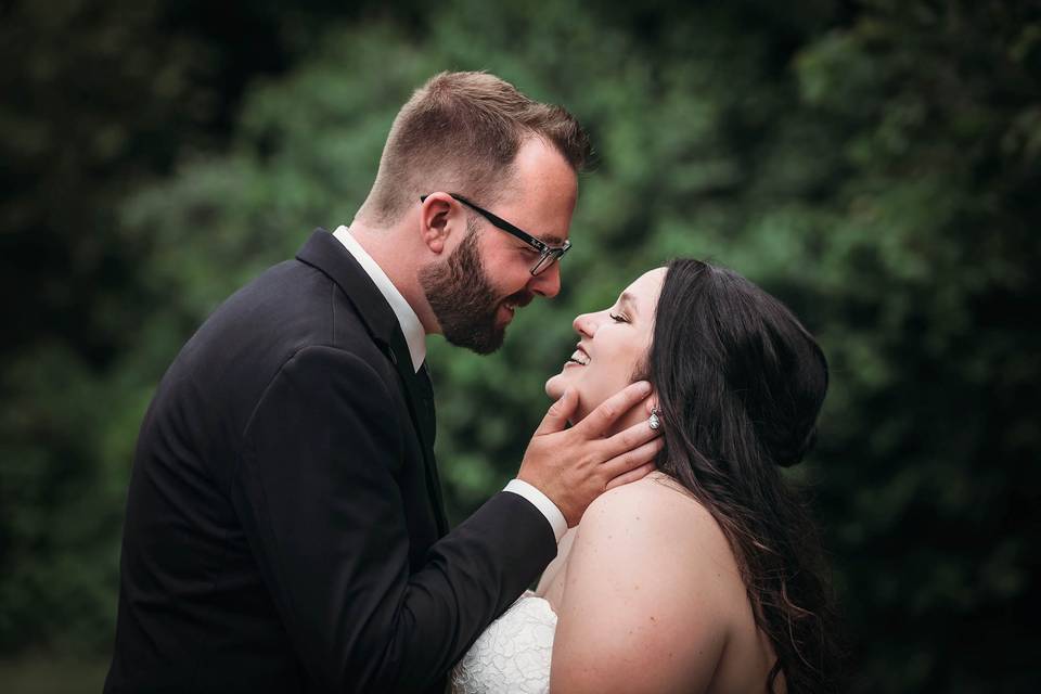 Groom embracing bride