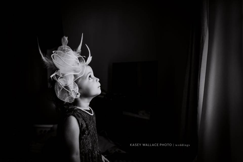 Child looking at bride's dress