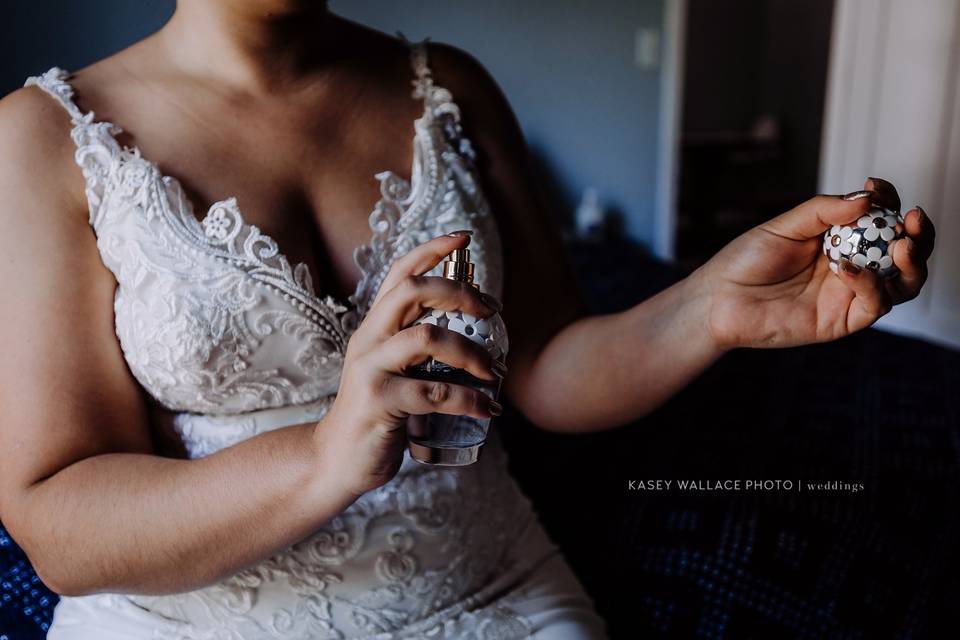 Bride applying perfume