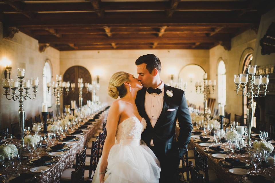 Couple kissing beneath arbor