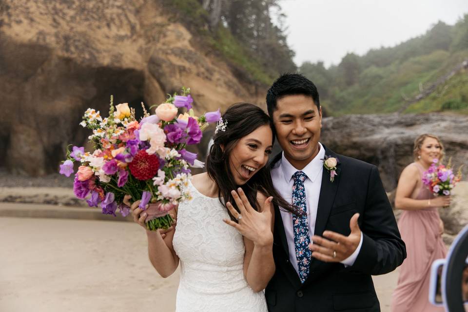 Bride and groom showing rings