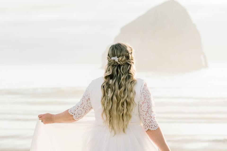 Bride dancing on beach