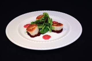 Seared sea scallops over pickled beet finished with a lemon beet vinaigrette