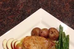Pork Chop with roasted red bliss potato, asparagus and fresh apple sauce