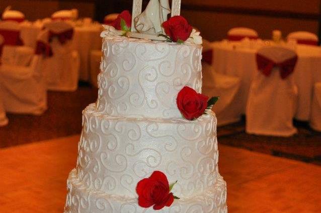 4-tier wedding cake with flowers and figurines