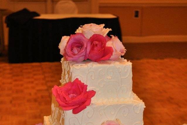 Pink petals on wedding cake