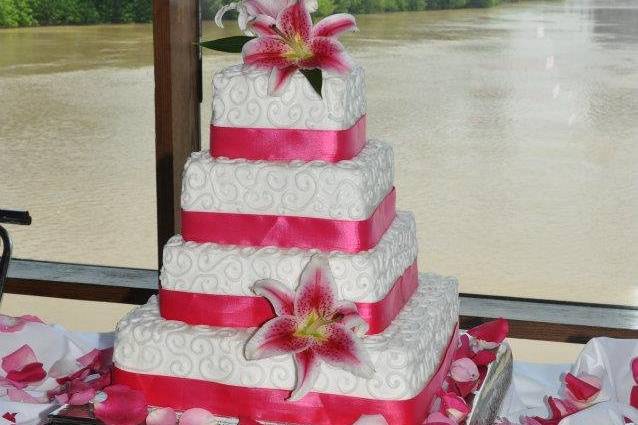 4-tier wedding cake with pink ribbons