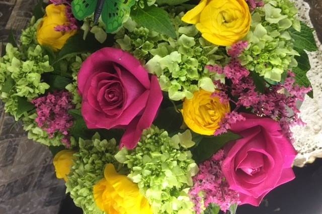 Green hydrangeas and pink and yellow roses