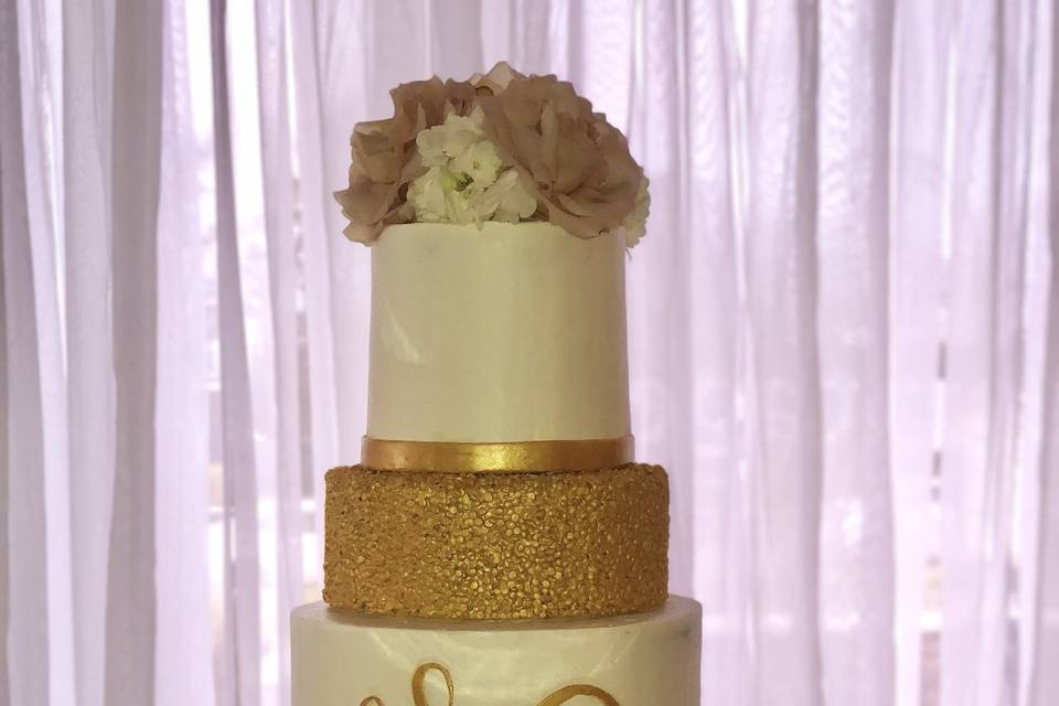 Cream and gold monogrammed cake