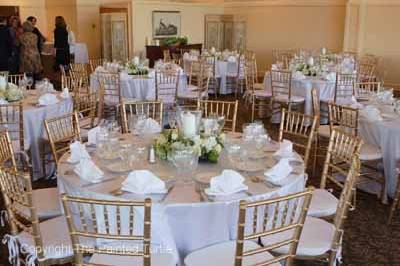 Floor length table cloths with Chivari chairs in gold.