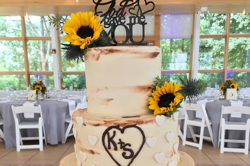 Three tier wedding cake with sunflowers