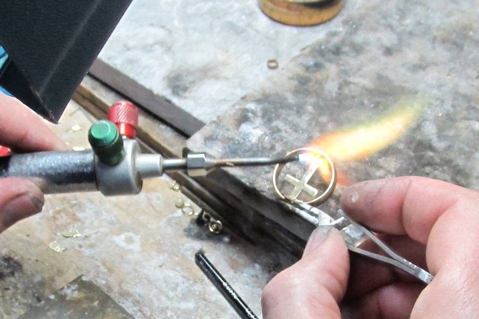 Attaching a cross to a wedding band A customer wanted to do something with her dads wedding band.