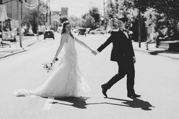 Bride and groom crossing stree