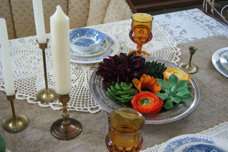 tabletop decor- lace table cloth, burlap runner, brass candle sticks, silver bowls, vintage china, vintage stemware, floral