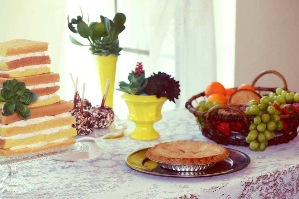 dessert table- platters, baskets, cake plates, vases, cake, and floral on a lace table cloth