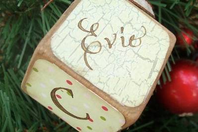 This is a vintage style baby block ornament that I offer in my Etsy shop. It is created with antique looking papers made to look old and worn. It is a 1.5 inch wood block and it hung from a ribbon. Here is the link if you are interested in seeing more.http://www.etsy.com/listing/82585337/vintage-style-baby-block-ornament